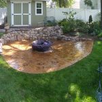 concrete patio with fire pit on top