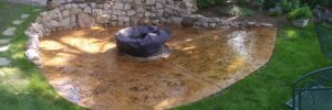 concrete patio with fire pit on top