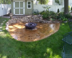 concrete patio with fire pit on top