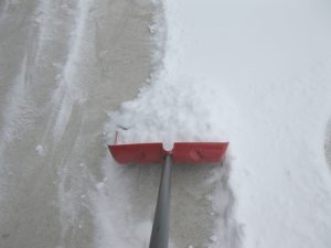 shoveling concrete driveway in winter