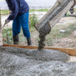 Workers level out the concrete mix at a construction site. Technologies